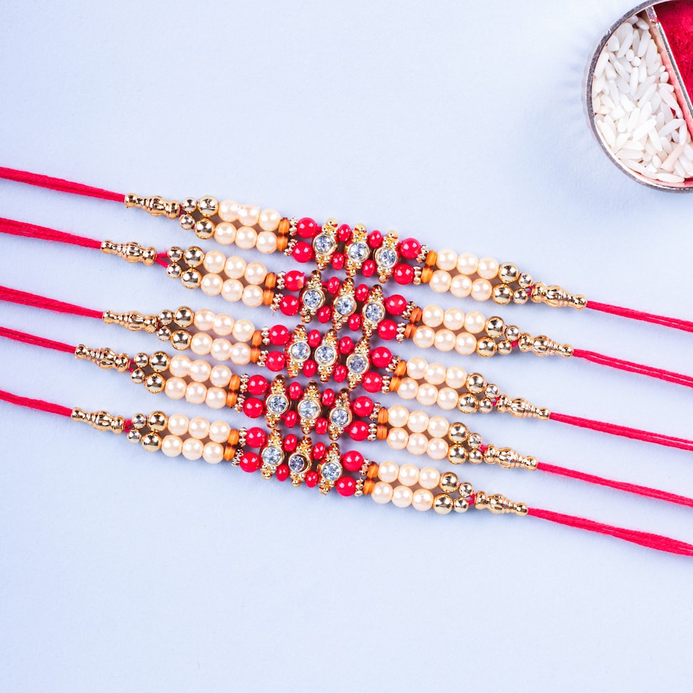  Set Of 5 White And Red Pearl Rakhi
